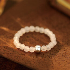 White jade beaded elastic ring with sterling silver accent bead close-up