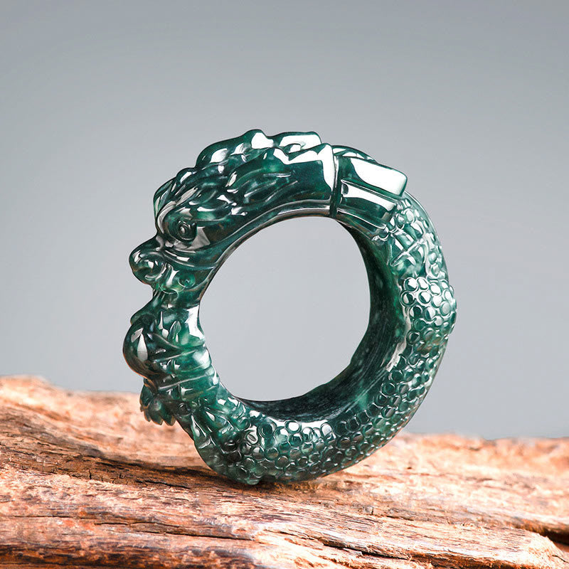Natural cyan jade dragon ring front three-quarter angle showing dark emerald green jade with integrated dragon wrap design