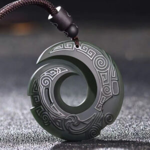 Hetian cyan jade peace buckle necklace pendant with traditional carved spiral pattern and braided cord, oblique front view