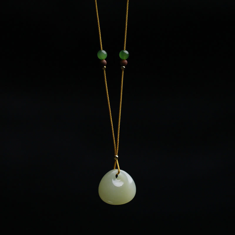 Hetian jade prosperity pendant necklace with small bag charm, light green rounded jade stone on yellow cord with gold and brown wooden spacer beads, front view