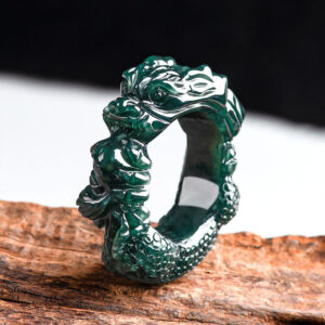 Cyan jade dragon carved ring shown in high side perspective view displaying emerald green jade with intricate dragon carving and scaled surface texture