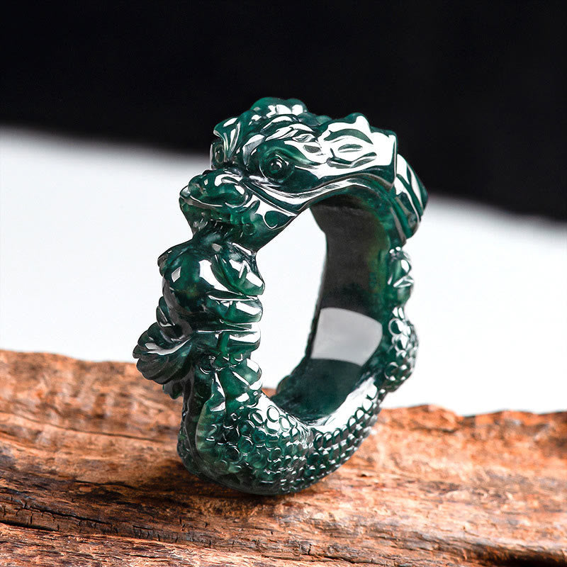 Cyan jade dragon carved ring shown in high side perspective view displaying emerald green jade with intricate dragon carving and scaled surface texture