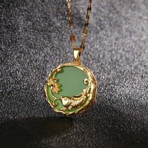 Cyan jade koi fish lotus pendant necklace with gold embossed frame close-up view on dark background