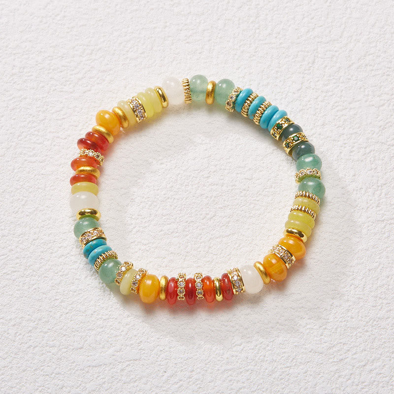 Rainbow jade red agate confidence bracelet flat lay top view with gold spacers and mixed gemstone beads