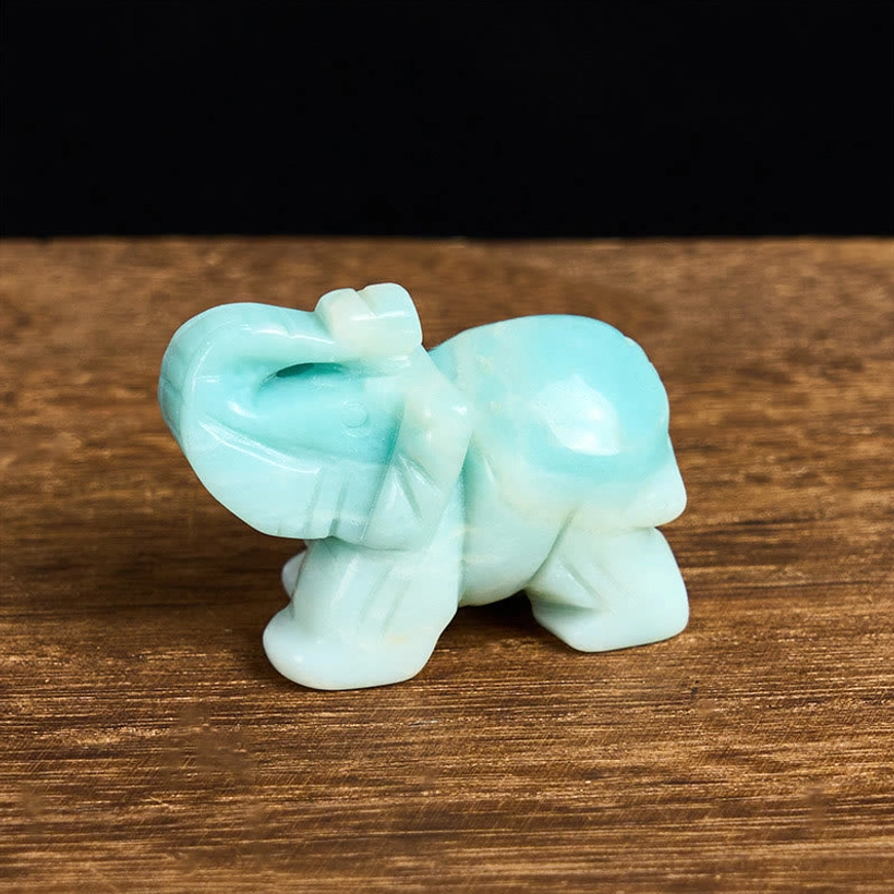 Natural amazonite stone elephant sculpture polished smooth on light tabletop