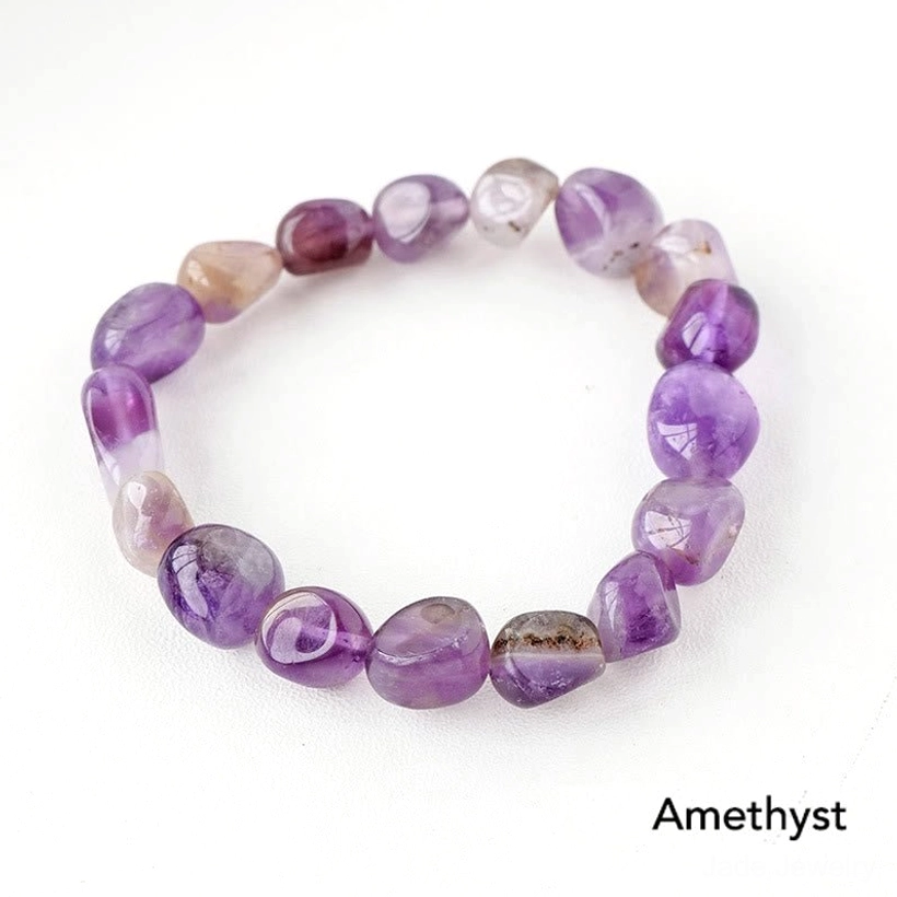 Pure purple amethyst tumbled stone beaded bracelet on white background overhead view