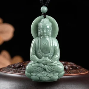 Amitabha Buddha jade pendant front view carved with lotus base and celestial halo on dark wooden stand
