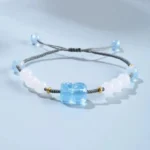 Aquamarine Pixiu Hetian white jade healing bracelet flat lay with adjustable braided cord and blue beads