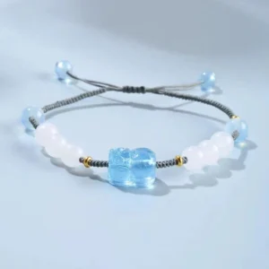 Aquamarine Pixiu Hetian white jade healing bracelet flat lay with adjustable braided cord and blue beads