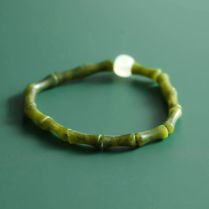Complete green bamboo jade bracelet circle layout, olive green carved beads with central white jade bead