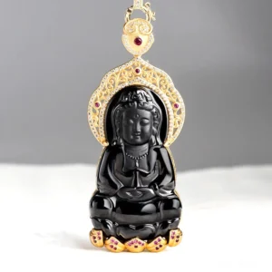 Black jade Kwan Yin pendant front view with ornate gold frame and red gem accents on minimalist background