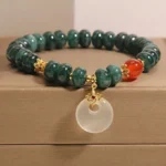 Blue jade beads peace buckle prosperity bracelet overhead view, showing complete circular design with white jade pendant and red agate accents