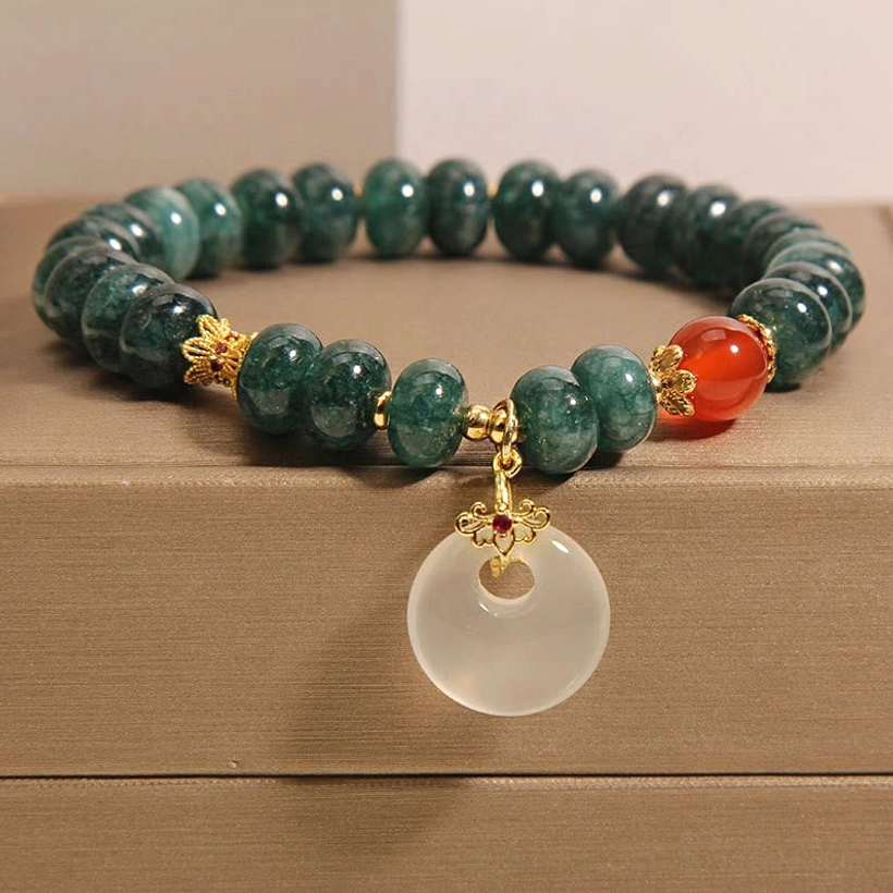Blue jade beads peace buckle prosperity bracelet overhead view, showing complete circular design with white jade pendant and red agate accents