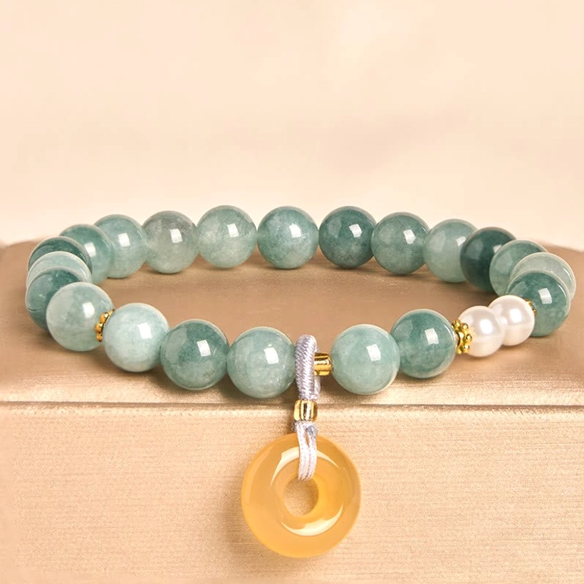 Blue jade peace buckle beaded bracelet with white pearls and yellow jade pendant displayed on beige jewelry tray, featuring gradient green jade beads