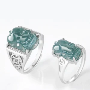 Two adjustable blue jade Pixiu rings in women's and men's sizes with 925 sterling silver inlay, flat lay comparison view