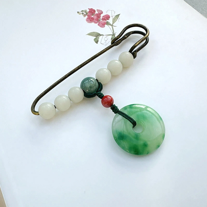 Antique bronze safety pin brooch strung with white jade beads and green jade peace buckle pendant