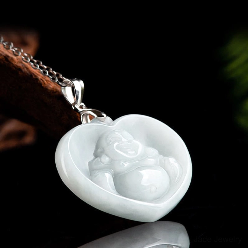 Carved laughing Buddha jade heart pendant in light celadon tone, right oblique angle view