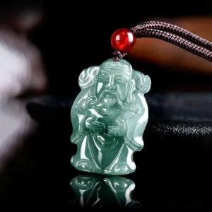 Caishen jade prosperity pendant three-quarter angle view showing carved details and mirrored reflection on dark surface