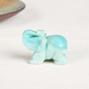 Carved amazonite elephant close-up showing smooth polished turquoise stone and raised trunk detail