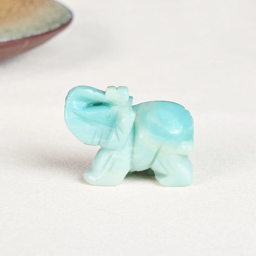 Carved amazonite elephant close-up showing smooth polished turquoise stone and raised trunk detail