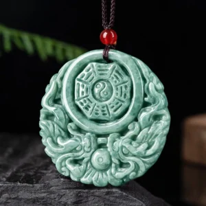 Detailed close-up of hand-carved jade pendant showing intricate dragon and yin yang motifs