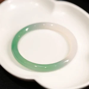 Top view of two-tone chalcedony agate bangle showing smooth polished surface and gentle color transition