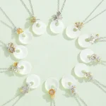 Collection of chalcedony flower harmony pendant necklaces with silver and gold clasps, flat lay overhead view