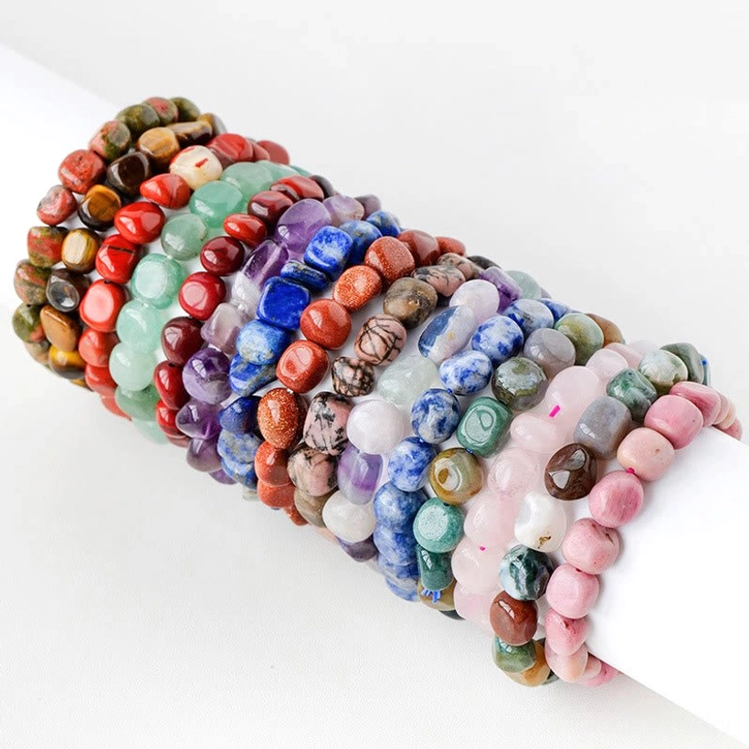 Multi-stone irregular natural crystal beaded bracelet with mixed tumbled gemstones in overhead close-up view on white background