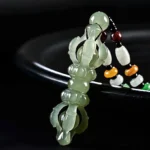 Cyan Hetian jade Dorje Vajra pendant necklace with colorful decorative beads on black background
