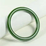 Cyan jade bangle bracelet with smooth polished finish displayed on minimalist background