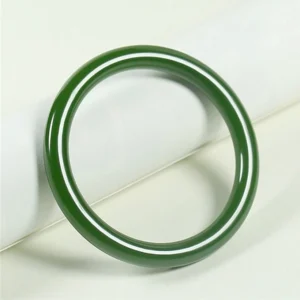 Cyan jade bangle bracelet with smooth polished finish displayed on minimalist background