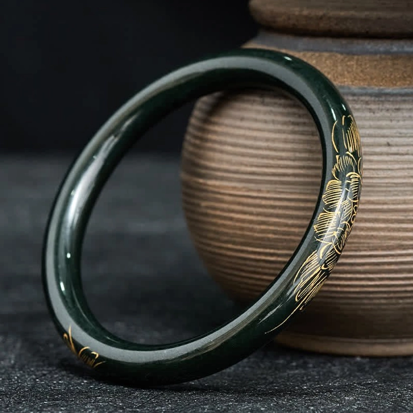 Polished cyan jade lotus koi fish bangle bracelet with gold rim details, front angle view