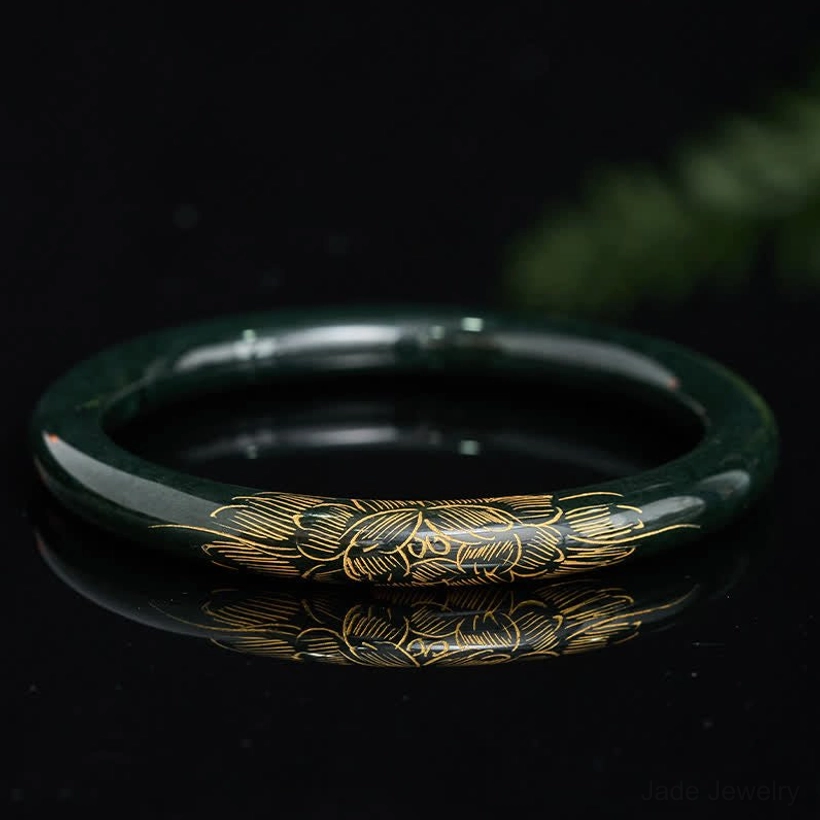 Natural cyan jade bangle bracelet with carved lotus and koi fish motifs, top-down flat lay