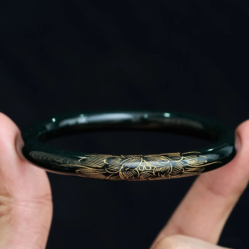 Woman wearing cyan jade lotus koi bangle bracelet, hand holding close-up view with gold details