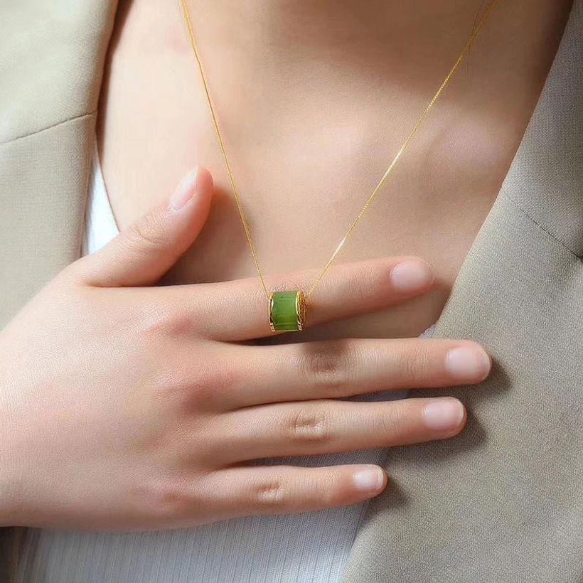 Delicate cyan jade barrel necklace worn on upper body with formal white lace blazer, styling inspiration minimalist jewelry