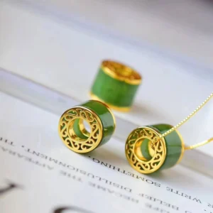 Two cyan jade barrel pendant designs with hollow and solid gold frames, flat lay comparison on white background