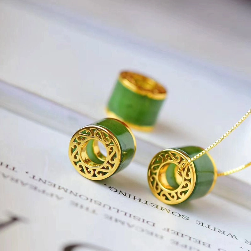 Two cyan jade barrel pendant designs with hollow and solid gold frames, flat lay comparison on white background