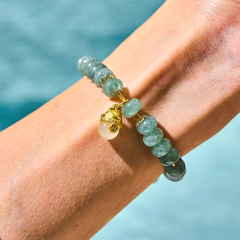 Cyan Jade Healing Bracelet Worn on Wrist - Light Blue Background Side View