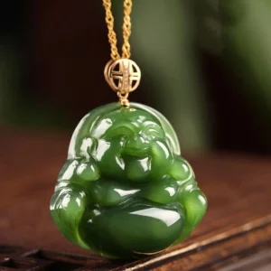 Hetian cyan jade Buddha pendant with fortune charm gold clasp and chain on wooden table, close-up front perspective