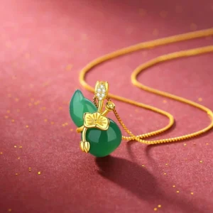 Alternative view of cyan jade gourd pendant necklace with gold lotus ornament and delicate gold chain, showcasing stone detail