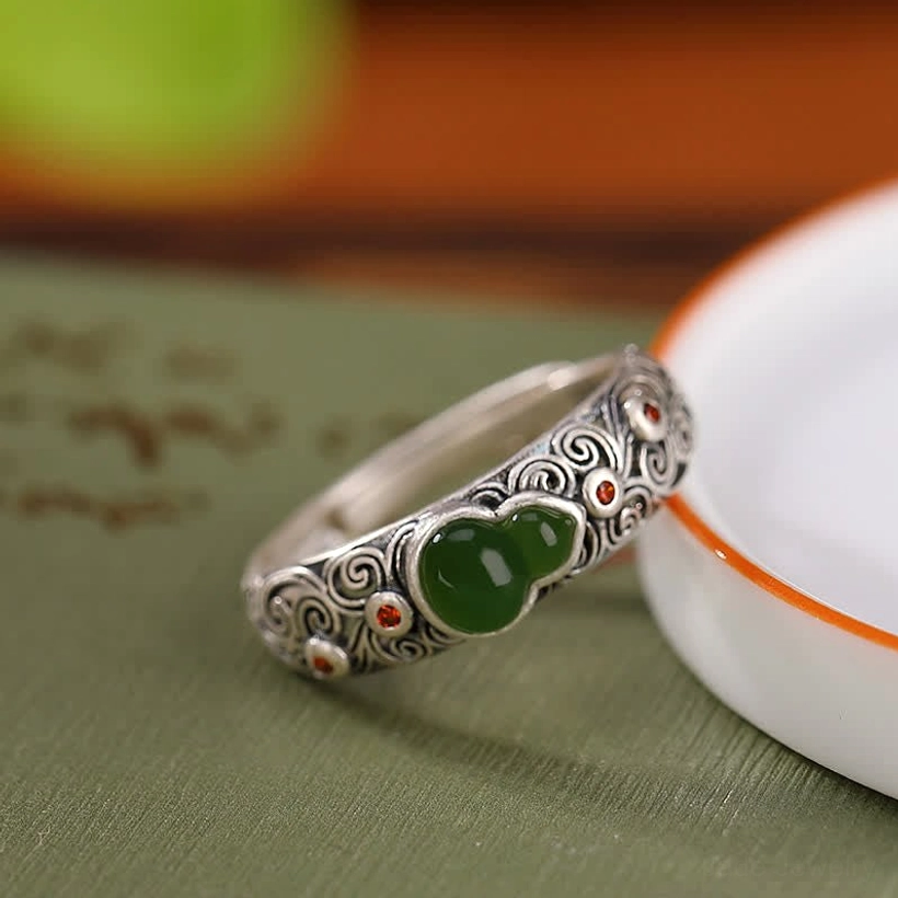 Cyan jade sterling silver gourd ring with adjustable open design on tabletop vintage styling