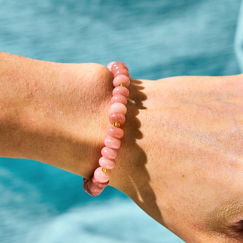 Plain Cyan Jade Beaded Bracelet - Top-Down Wrist View with Blue Water Background