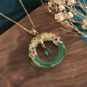 Cyan jade hollow pendant necklace featuring delicate gold floral filigree design with pink gems and chain detail