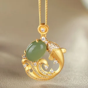 Hand-carved cyan jade koi fish necklace pendant with paved zirconia wave design, vertical close-up view