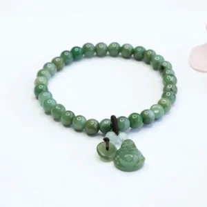 Cyan jade laughing Buddha bracelet with smooth round jade beads and hand-carved Buddha pendant on elastic string, flat lay view