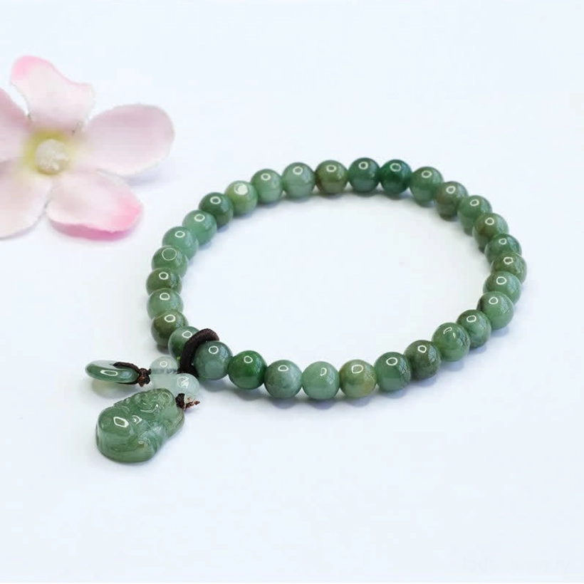 Cyan jade Laughing Buddha bracelet with round beads and carved pendant on white background, showing premium elastic closure