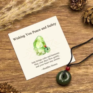 Cyan jade peace buckle necklace flat lay with greeting card, pinecones, and dried wheat on wooden table