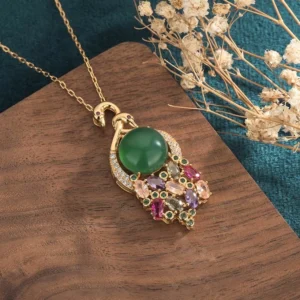 Cyan jade necklace side angle view showing ornate peacock design with gemstone tassel charms and gold metal setting