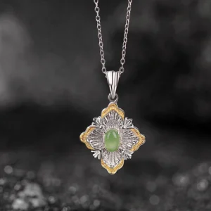 Dual-tone jade pendant necklace front view showing filigree silver details and central oval cyan jade stone