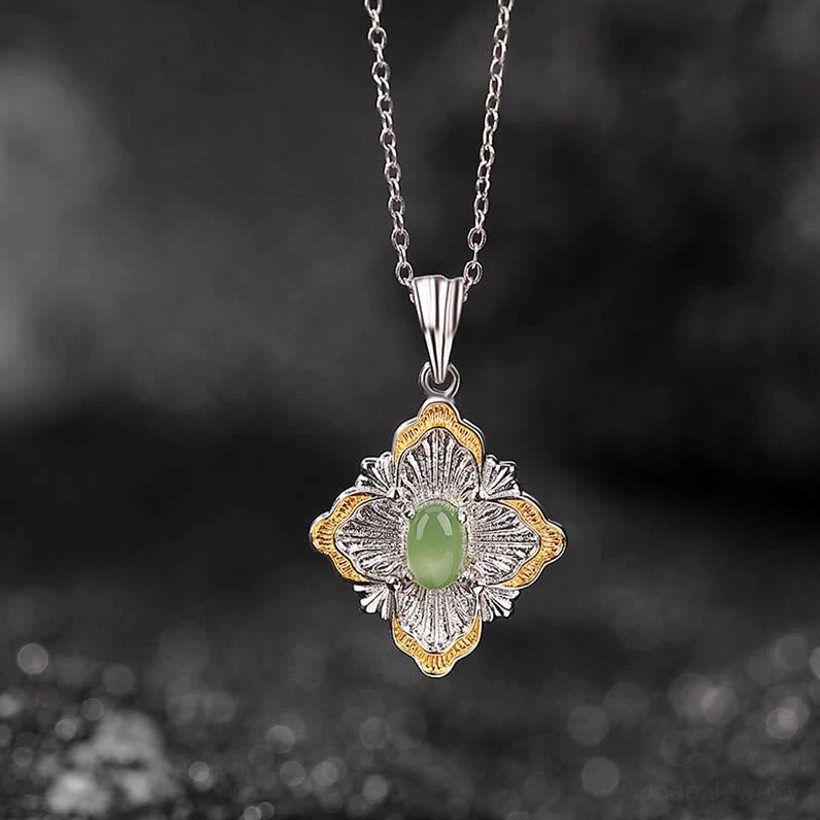 Dual-tone jade pendant necklace front view showing filigree silver details and central oval cyan jade stone